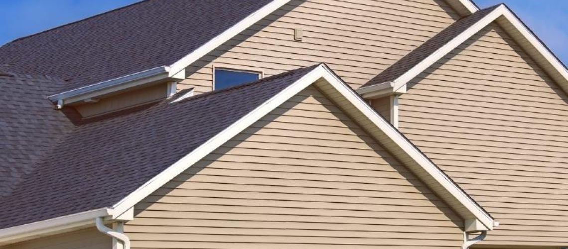 residential property exteriors with asphalt shingles roof and gutter installed evansville in